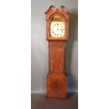 A 19th Century Mahogany And Oak Long Case Clock, the arched hood with broken swan neck pediment