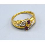 An 18ct Yellow Gold Diamond And Ruby Ring set with two rubies flanked by diamonds within a crossover