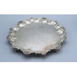 A Victorian Silver Salver of shaped scallop outline with engraved decoration upon four low feet,