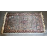 A North West Persian Style Woollen Rug with an all over design upon a blue, red and cream ground