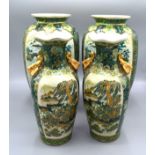 A Pair of Chinese Vases decorated with landscapes upon green grounds and highlighted in gilt,
