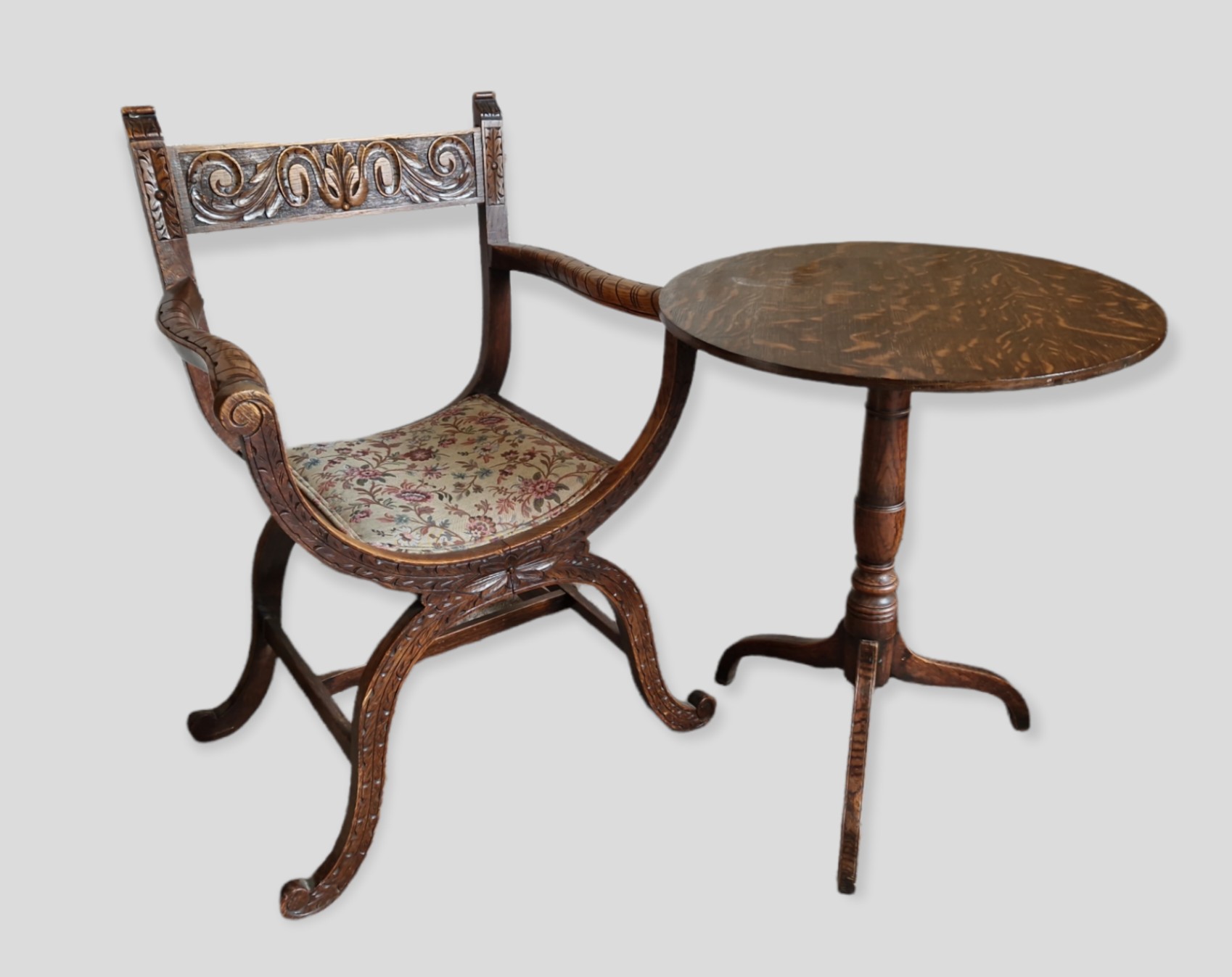 A Carved Oak Crossover Armchair together with a 19th Century Oak Pedestal Table