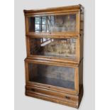 A Globe Wernicke Oak Bookcase with three glazed doors above a drawer, 86.5 cms wide, 35.5 cms