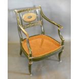 A Regency Painted Armchair, the oval cane and pierced splat back above a cane seat with shaped arms,