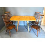 An Ercol Drop Flap Dining Table, 137 x 74 cms, 71cms high, together with a set of four Ercol stick