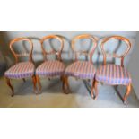 A Set of Four Victorian Walnut Balloon Back Dining Room Chairs each with a pierced carved rail