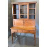 An Early 20th Century Oak Dresser, the moulded cornice above a central glazed door flanked by