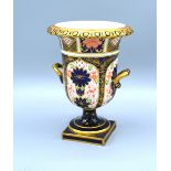 A Royal Crown Derby Porcelain Two Handled Pedestal Urn decorated in the Imari palette, 16 cms tall