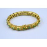 A 14ct. Gold Emerald Set Panel Bracelet, 25.6gms, 18cms long