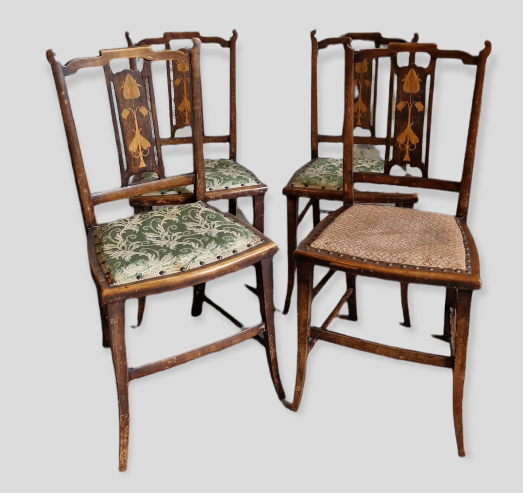 A Set Of Four Art Nouveau Mahogany Inlaid Side Chairs, each with a tulip inlaid back raised upon