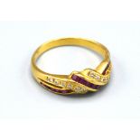 A Yellow Metal Ruby And Diamond Set Ring of crossover form, 2.5gms. ring size M