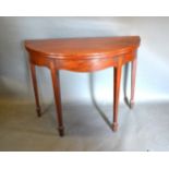 A 19th Century Mahogany Demi Lune Card Table, the hinged top above a shaped frieze with shell carved