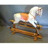 A Dapple Grey Rocking Horse with wooden stand, 124cms long
