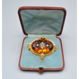 A 19th Century Brooch retailed by Tiffany & Co. set with a large orange topaz encrusted with