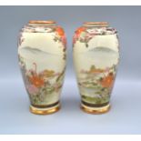 A Pair of Japanese Satsuma Baluster Form Vases decorated with landscapes and highlighted in gilt,