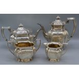 A George V silver four piece tea service, comprising teapot, hot water pot, cream jug and sucrier,