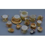 A Royal Worcester blush ivory miniature pin box and cover, together with a collection of related