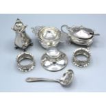 A Sheffield Silver Tea Strainer together with other items of silver to include two condiments, three