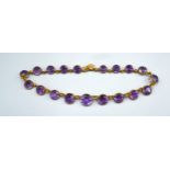 A Yellow Metal Amethyst Set Necklet set with 19 graduated amethysts, claw set, 42 cms long