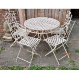 A Painted Garden Table of circular form together with four matching folding chairs
