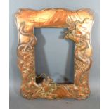 A Japanese Meiji Period Photograph Frame decorated in relief with serpents, 32 x 26 cms