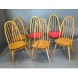 A Set of Six Ercol Dining Chairs (4 + 2) each with a spindle back above a panel seat raised upon