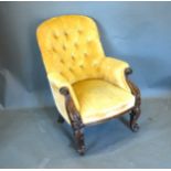 A Victorian Mahogany Drawing Room Armchair with a button upholstered back above a stuff over seat