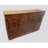 A Limed Oak Side Cabinet, the four doors with Gothic tracery panels, 169cms wide, 43cms deep, 107cms
