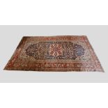 A North West Persian Large Woollen Rug with a central medallion with an all over design upon a