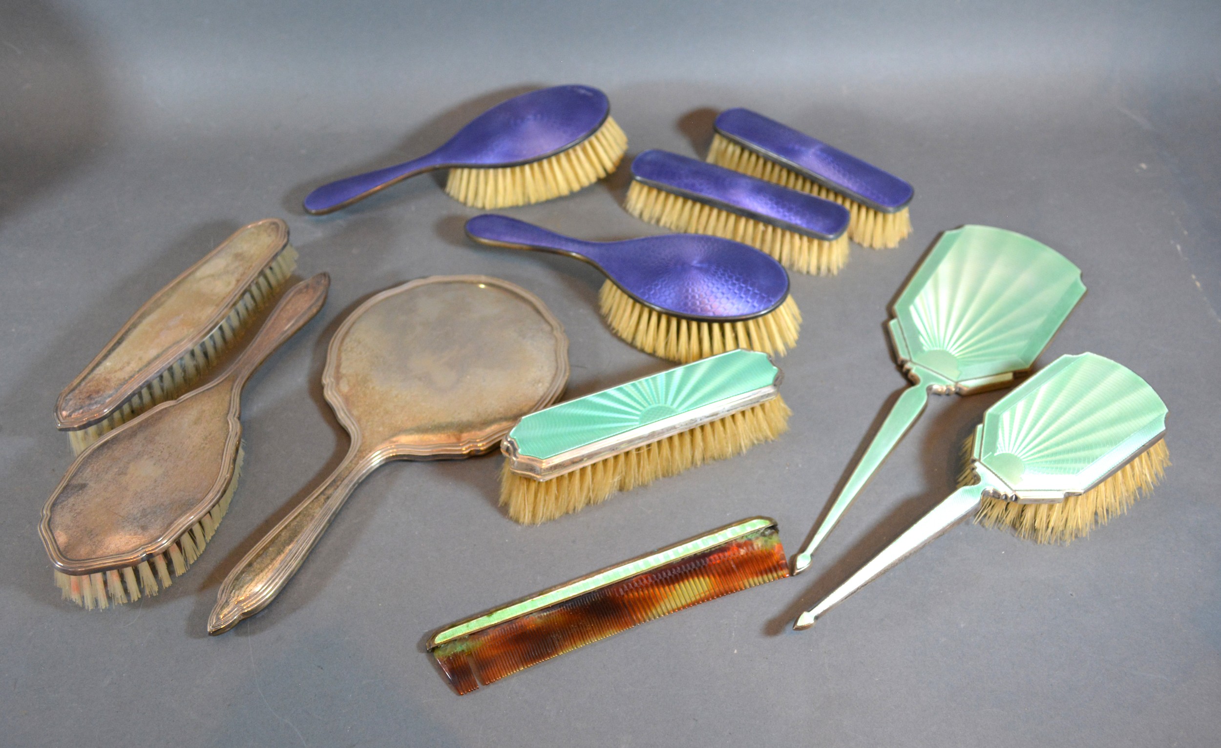 A Birmingham Silver and Enamel Decorated Four Piece Dressing Table Set together with a similar