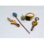 A yellow metal signet ring set stone together with a stick pin, an earstud and two watch keys