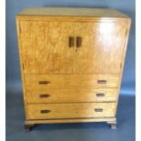 An Art Deco Burr Maple Bedroom Suite comprising linen cabinet, wardrobe, a pair of single bedsteads,