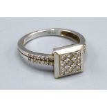 An 18ct. White Gold Square Set Diamond Ring, 3.4gms. ring size M