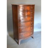 A 20th Century Mahogany Bow Fronted Tall Chest of six drawers with metal handles, raised upon