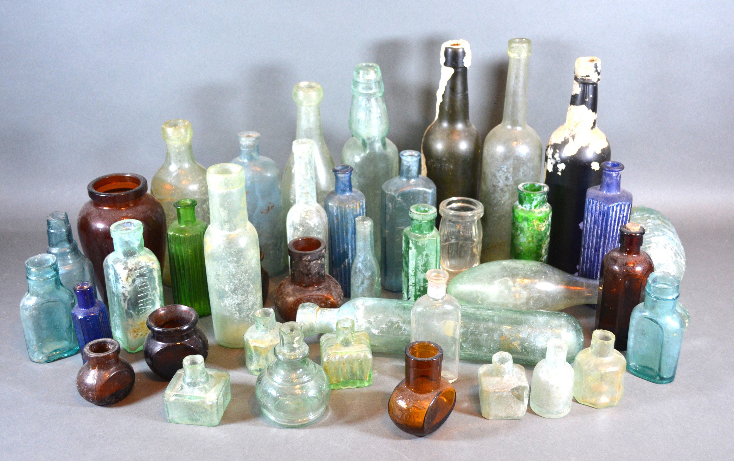 A Collection of Early Glass Bottles to include Bovril and Marmite