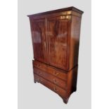 A 19th Century Mahogany Linen Press, the moulded cornice above two panelled doors enclosing