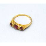 An 18ct. Gold Ruby and Diamond Ring set with three rubies interspaced with four diamonds, 3.4 gms