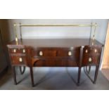 A Regency Style Sideboard with a brass galleried back above two central drawers flanked by