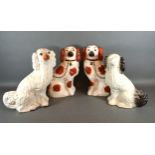 A Pair of Staffordshire Models of Dogs with iron red decoration together with two other similar