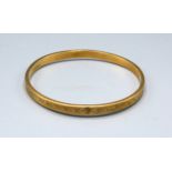 A 9ct gold engraved bangle, 12gms, 8.5cms diameter