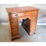 A 20th Century Walnut Queen Anne Style Small Pedestal Desk, the tooled leather inset top with