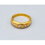 An 18ct. Gold Three Stone Diamond Ring 6.1 gms ring size P