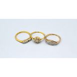 An 18ct. Gold Cluster Ring together with another 18ct. gold ring and a 9ct. gold dress ring