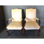 A Pair Of George III Style Armchairs each with an upholstered back and seat with scroll arms, raised