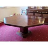 A 20th Century Mahogany Octagonal Centre Table, the cross banded top above a square column 180 cms