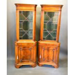 A Pair Of Mahogany Standing Corner Cabinets, the moulded tops above astragal glazed doors, the lower