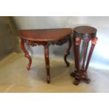 A Mahogany Demi-Lune Console Table with a moulded top above a carved pierced frieze, raised upon