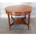 A Walnut Circular Centre Table, the moulded top above a pierced frieze and raised upon four