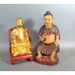 A Chinese Gilt Wood Figure Of A Man Upon A Chair 20cms tall together with another similar carved