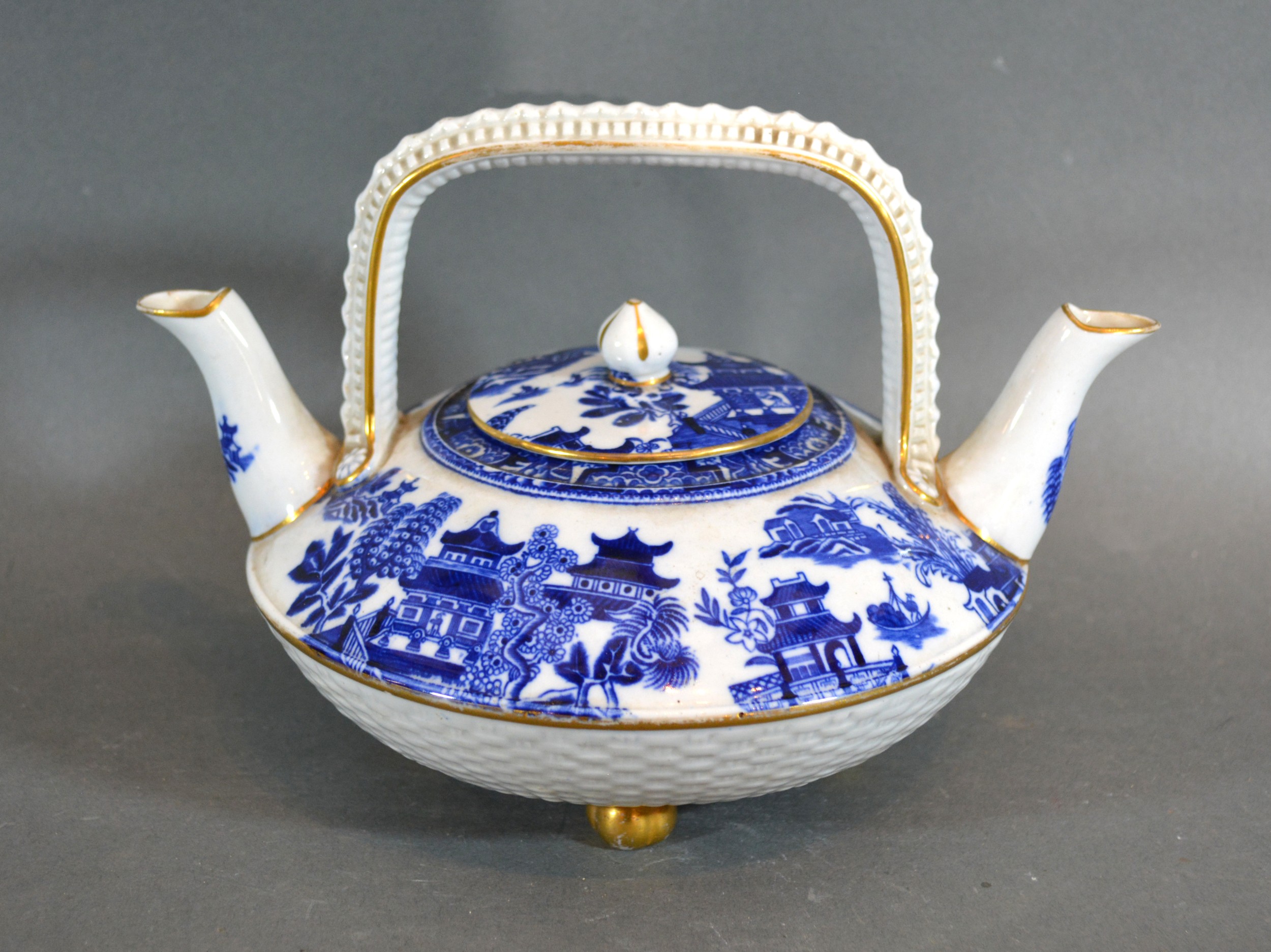 A 19th Century Worcester Double Spouted Teapot decorated in underglaze blue and with gilded feet